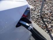 Tesla cars change at the Tesla Supercharger station in the Fred Meyer parking lot in Salmon Creek.