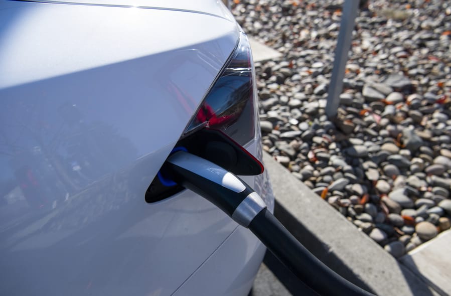 Tesla cars change at the Tesla Supercharger station in the Fred Meyer parking lot in Salmon Creek.