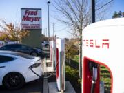 Teslas charge at the Tesla Supercharger station in the Fred Meyer parking lot in Salmon Creek in 2019.