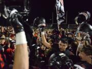 The Camas Papermakers celebrate a win against Union at Doc Harris Stadium in Camas on Friday night, November 1, 2019. Camas beat Union 28-14.