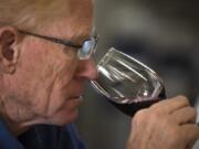 Steve Shelton with the Columbia Willamette Enological Society smells a glass of wine during a planning session with chefs in the Mess Hall at the Fort Vancouver National Site to create a menu of hors d&#039;oeuvres to pair with wines at an upcoming meeting.