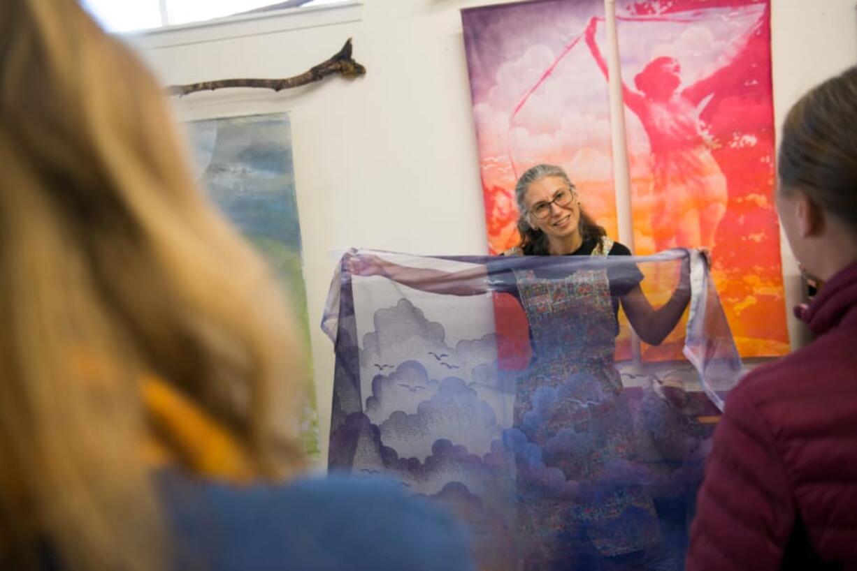 Sharon Svec shares some of her work with visitors during a tour of her studio Sunday in Vancouver. Svec was one of 50 Clark County artists who opened their doors for a self-guided tour Saturday and Sunday.