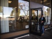 Scott Gibson chats with a friend outside of the Vancouver Navigation Center in Vancouver on Nov. 1. All entry into the building might soon be moved to this door instead of the side door under the awning. Gibson is currently living in a van and waiting for housing options.