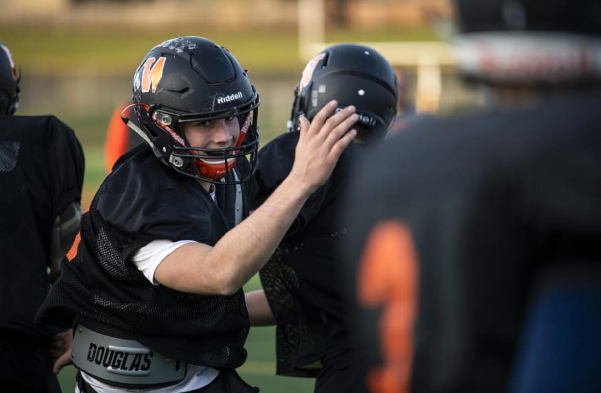 Washougal High School senior Brevan Bea, left, runs through drills with his teammates during practice at Fishback Stadium in Washougal.