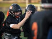 Washougal High School senior Brevan Bea, left, runs through drills with his teammates during practice at Fishback Stadium in Washougal.