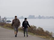 Vancouver residents Justin and Kelly Venetucci take in a foggy view of the Columbia River while enjoying a brisk, fall walk together Monday morning, Nov. 4, 2019. The couple said they try to walk together almost everyday although they wouldn't mind if blue skies made an appearance again. "I like the sunny fall," Kelly Venetucci said.