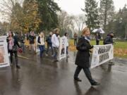 Vancouver Mayor Anne McEnerny-Ogle, right, leads a group of Gold Star families - families who&#039;ve lost a member to military service - during Saturday&#039;s 33rd annual Lough Legacy Veterans Parade at the Fort Vancouver National Site.