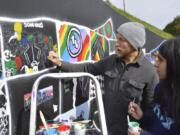 Washougal: Local muralist Travis London with Jemtegaard Middle School student Bianca Montoya, one of the students in the district&#039;s Club 8 after-school program who worked on a new mural in downtown Washougal.