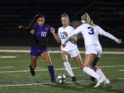 Columbia RiverÕs Yaneisy Rodriguez (10) fights for the ball against RidgefieldÕs Claire Jones (11) during the 2A district championship at Columbia River High School in Vancouver on Nov. 7, 2019. Ridgefield won 2-1.