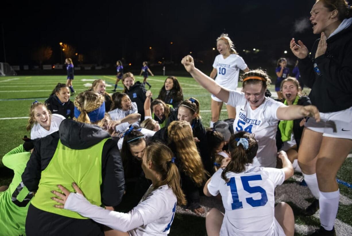 Ridgefield players celebrate their win over Columbia River.