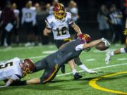 Prairie’s Jamien Farrell reaches for extra yards while being brought down by a Capital defender during a game at Battle Ground District Stadium on Friday night, Nov. 8, 2019.