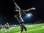 Prairie's Christian Lowry, left, and Zack Brown celebrate the Falcon's 73-35 win over the Capital Cougars at Battle Ground District Stadium on Friday night, Nov. 8, 2019.