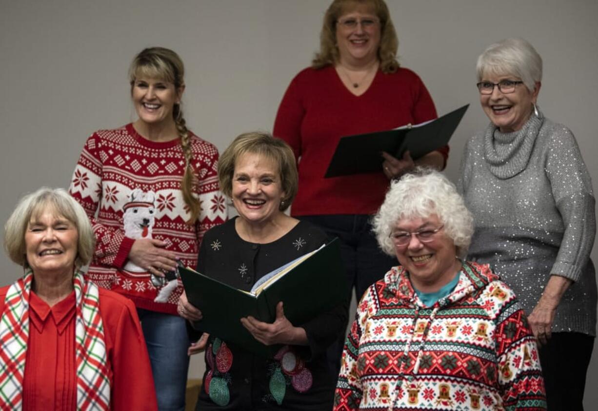 Members of the Columbia River Chorus -- including assistant director Connie Meuchel, lower left -- burst into laughter while teasing their director, Paul Olguin, during a recent rehearsal at Clark College.