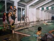 Westley Mejias greets his kids Diana, 4, Sarah, 6, and Manuel, 2, as he coaches at the Lacamas Athletic Club. The kids all take swimming lessons at the club, and Westley?s wife, Juana Santana, is on the masters swimming team. Mejias and his family moved to Camas after Hurricane Maria devastated Puerto Rico, where he coached swimming for a national team and the University of Puerto Rico.