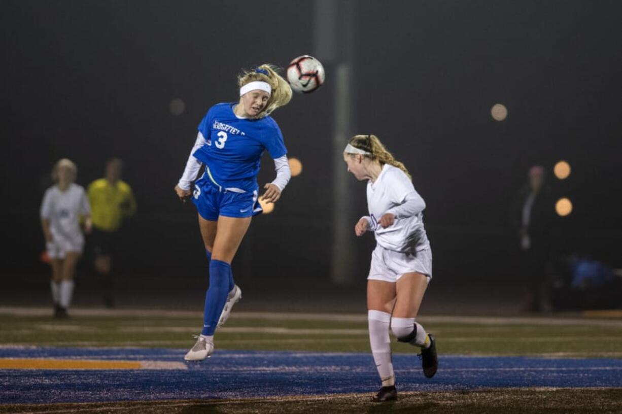 Ridgefield&#039;s Annika Farley (3) heads the ball during round one of the 2A state playoffs on Tuesday in Ridgefield on Nov. 12, 2019. Ridgefield defeated Sequim 3-0.