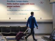 A commuter walks past a sign advertising the closure of Concourse A at Portland International Airport on Wednesday morning, the concourse&#039;s last day of operation.