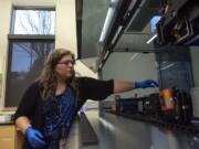 DNA Supervisor Heather Pyles demonstrates the lab&#039;s new $240,000 Hamilton Microlab Autolys STAR liquid-handling robot Friday morning at the Washington State Patrol Crime Lab in Vancouver.