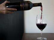 Heidi Griggs, manager of the joint Pepper Bridge Winery and Amavi Cellars tasting room, pours a glass of Pepper Bridge&#039;s 2013 Trine on Wednesday.