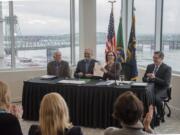 Roger Millar, Washington state secretary of transportation, from left, Washington Gov. Jay Inslee, Oregon Gov. Kate Brown and Kris Strickler, director of the Oregon Department of Transportation, applaud the signing of a memorandum of intent to replace the Interstate 5 bridge at the Murdock Charitable Trust on Monday morning, Nov. 18, 2019.