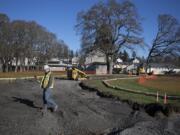 Tanner Wingfield of Braun Construction works near the new entryway to the East Barracks area at Fort Vancouver National Site on Nov. 21 The project is one of several designed to adjust vehicle circulation around the area in accordance with the National Park Service&#039;s master plan.