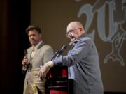 CooperCon founder Eric Ulis, left, and author Bruce Smith moderate a Cooper-themed trivia contest Saturday afternoon at the Kiggins Theatre in downtown Vancouver. The event moved from Portland to Vancouver this year and featured talks on specifics from the case, a film about Cooper and plenty of theories on what happened nearly 50 years ago. At top: Rick E. George, author of the book &quot;Cooper&#039;s Loot,&quot; listens as a forensics film plays during Saturday&#039;s CooperCon festivities.