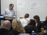 Jim Jensen, a manager of collaboration and learning with Southwest Washington Accountable Community of Health, left, talks with Randall Brewster during an Opioid Task Force meeting at Bridgeview Resource Center in Vancouver. Jensen is the task force facilitator.