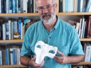 UC San Diego researcher Dick Norris holds a 3D printed version of a whale skull. One of his former students named the ancient whale after Norris and his father, Kenneth Norris.