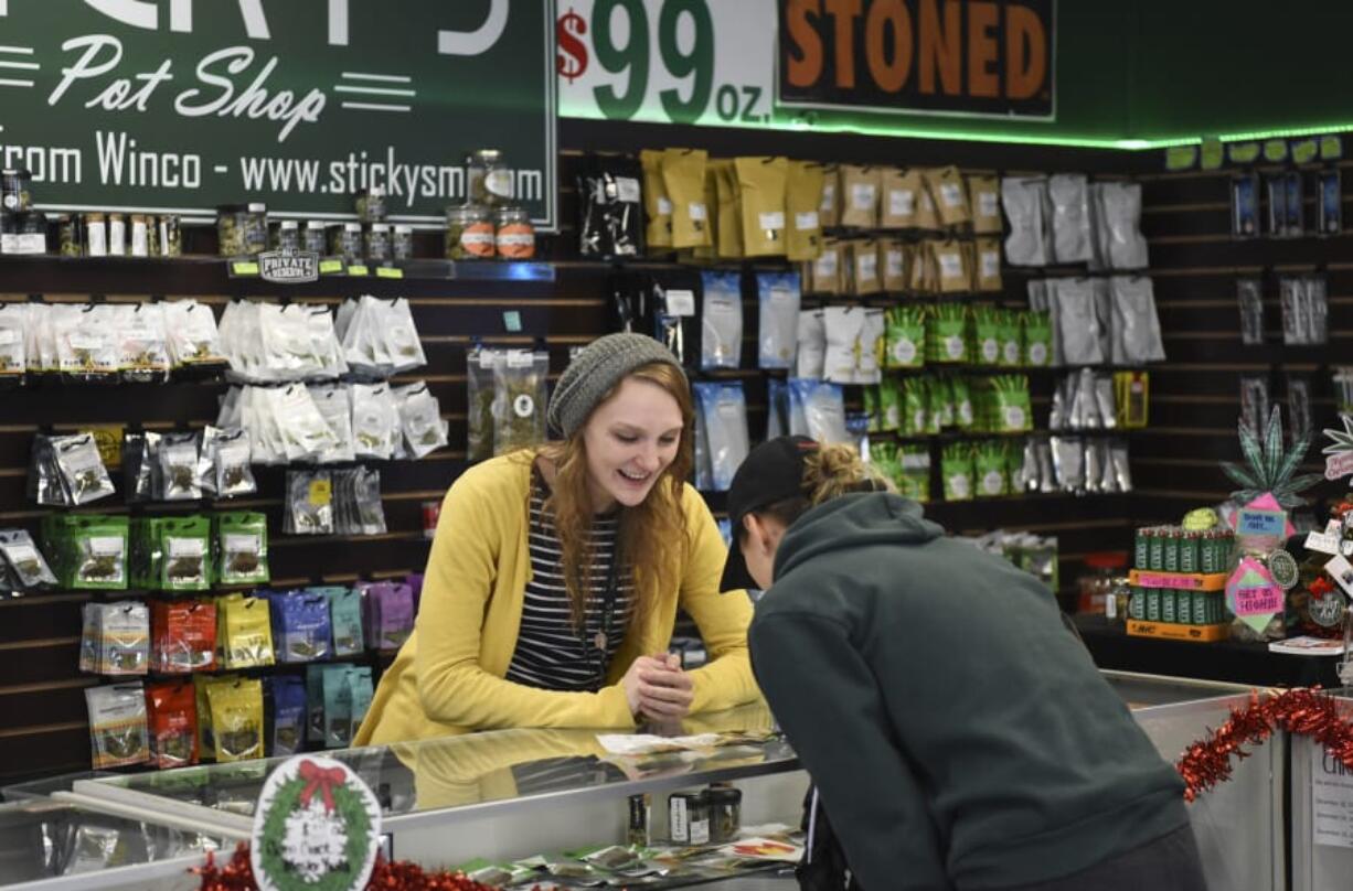 Sarah Rosdahl, budtender at Sticky&#039;s Pot Shop in Hazel Dell, helps a customer in 2017. The store was forced to close last year following a lengthy legal battle with Clark County. The Clark County council has since voted to lift a moratorium on marijuana businesses in unincorporated areas.