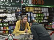 Sarah Rosdahl, budtender at Sticky&#039;s Pot Shop in Hazel Dell, helps a customer in 2017. The store was forced to close last year following a lengthy legal battle with Clark County. The Clark County council has since voted to lift a moratorium on marijuana businesses in unincorporated areas.