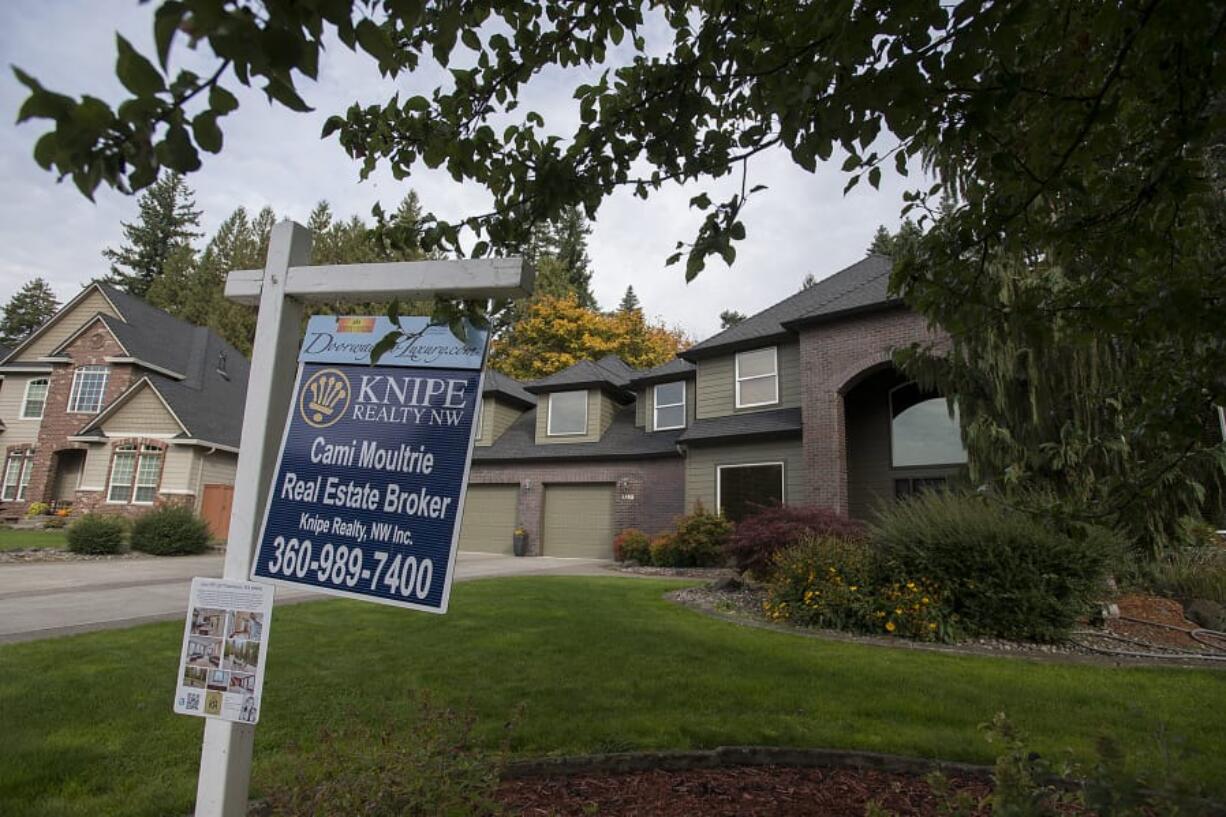 A real estate sign is posted outside a Salmon Creek home for sale on Oct. 15.