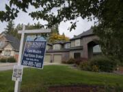 A real estate sign is posted outside a Salmon Creek home for sale on Oct. 15.