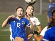 Mountain View&#039;s Ellie White (12) tries to bring down a ball while fending off Lakes&#039; Aly Bryan in a 3A bi-district girls soccer game Tuesday at McKenzie Stadium.