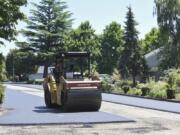 Road paving crews from Lakeside Industries pave Southeast 24th Street at the intersection of Southeast 150th Avenue on July 12, 2017. Summer 2017 was the first time Vancouver was able to take full advantage of its Transportation Benefit District, resurfacing 23 miles of road and applying preservation treatments to another 115 miles.