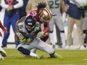 San Francisco 49ers cornerback Richard Sherman (25) tackles Seattle Seahawks wide receiver Tyler Lockett (16) during the first half of an NFL football game in Santa Clara, Calif., Monday, Nov. 11, 2019.