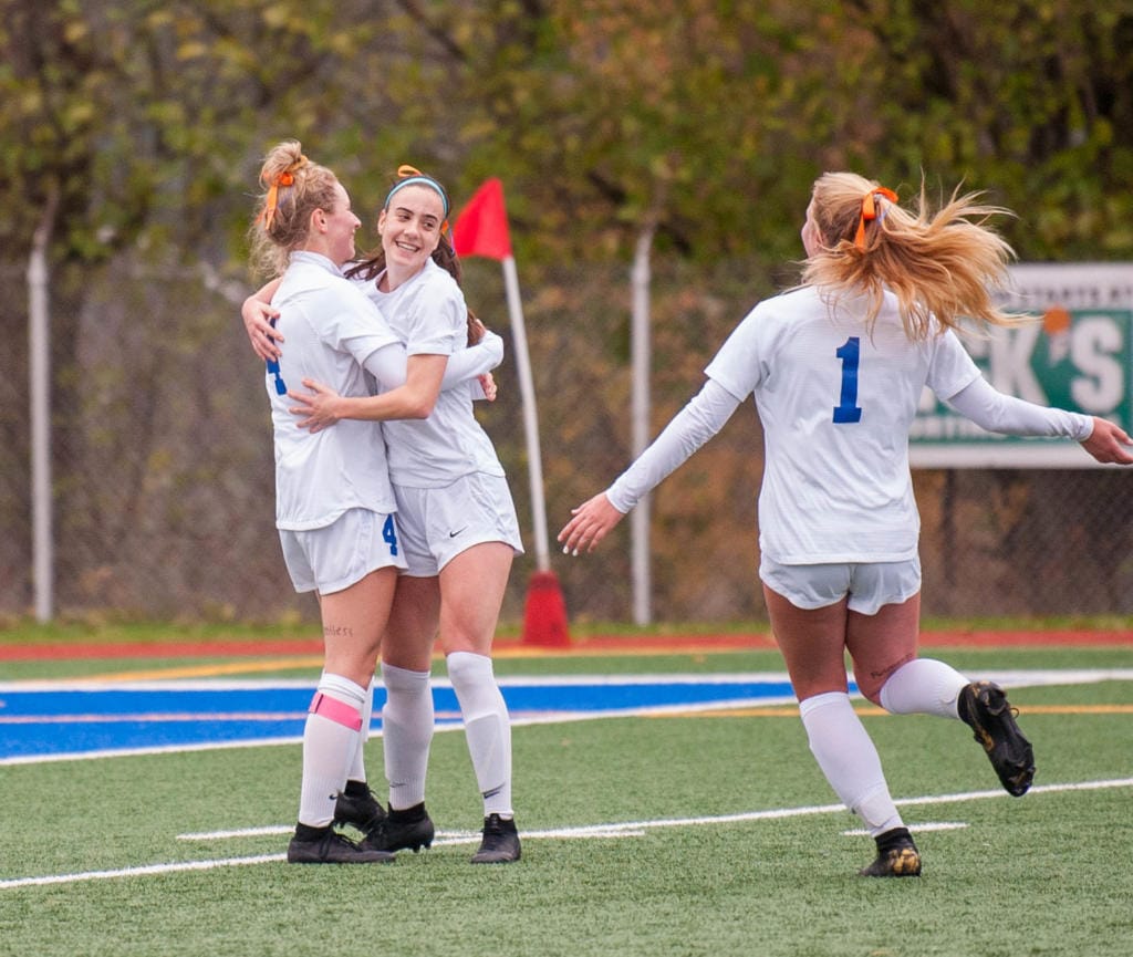 Brooke Weese, Taylor Hope and Elizabeth Farley celebrate Weese's second goal in Ridgefield's win over Selah in the 2A third-place game Saturday at Shoreline Stadium.