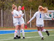 Brooke Weese, Taylor Hope and Elizabeth Farley celebrate Weese's second goal in Ridgefield's win over Selah in the 2A third-place game Saturday at Shoreline Stadium.