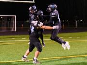 HockinsonÕs Jake Rogers (75), Jason Kerr (31) and Aden Bonife (80) celebrate after winning a quarterfinal game against Lakewood on Saturday, Nov. 23, 2019, at Battle Ground District Stadium. The Hawks won the game 29-28. (Molly J.