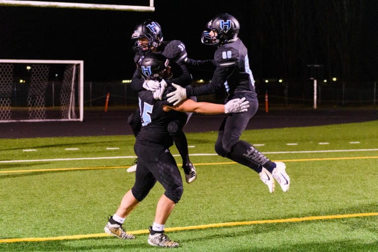 HockinsonÕs Jake Rogers (75), Jason Kerr (31) and Aden Bonife (80) celebrate after winning a quarterfinal game against Lakewood on Saturday, Nov. 23, 2019, at Battle Ground District Stadium. The Hawks won the game 29-28. (Molly J.