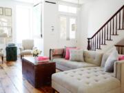 Kim Leggett prefers neutral walls and upholstery to get an authentic farmhouse style. In this renovated Brooklyn brownstone, a simple tufted sectional anchors the space.