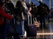 Travelers wait in line Nov. 21, 2018, before going through Transportation Security Administration screening at Ronald Reagan National Airport in Washington.