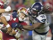 Seattle Seahawks defensive end Jadeveon Clowney (90) tries to take down San Francisco 49ers quarterback Jimmy Garoppolo during the the game on, Monday, Nov. 11, 2019.