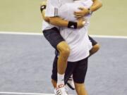 United States' Mike Bryan, left, jumps into his brother Bob Bryan's arms after defeating Russia's Igor Andreev and Nikolay Davydenko 7-6 (4), 6-4, 6-2 in the title-clinching Davis Cup Final doubles match on Saturday, Dec. 1, 2007 in Portland. The twins announced on Wednesday, Nov. 13, 2019 that they will retire after playing in the 2020 U.S. Open.