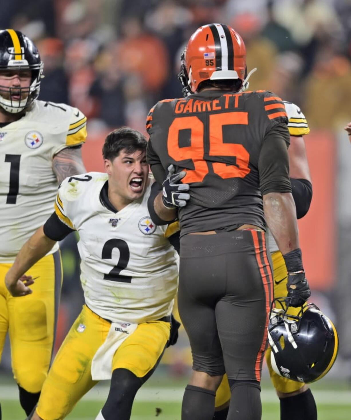 Pittsburgh Steelers quarterback Mason Rudolph (2) goes after Cleveland Browns defensive end Myles Garrett (95) during the second half of an NFL football game Thursday, Nov. 14, 2019, in Cleveland. The Browns won 21-7.