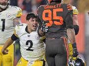 Pittsburgh Steelers quarterback Mason Rudolph (2) goes after Cleveland Browns defensive end Myles Garrett (95) during the second half of an NFL football game Thursday, Nov. 14, 2019, in Cleveland. The Browns won 21-7.