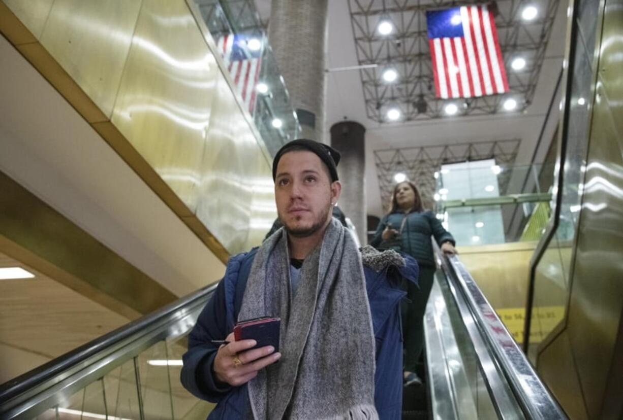 Mart?n Batalla Vidal takes an escalator into the Port Authority Bus Terminal in New York to take a bus to Washington, Monday, Nov. 11, 2019. Vidal is a lead plaintiff in one of the cases to preserve the Obama-era program known as Deferred Action for Childhood Arrivals and has seen his name splashed in legal documents since 2016, when he first sued in New York. His case will be heard at the Supreme Court beginning Tuesday.