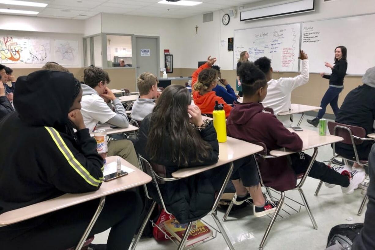 FILE - In this April 15, 2019, file photo, instructors from Raphael House lead a classroom discussion about consent and healthy relationships with a class of sophomores at Central Catholic High School in Portland, Ore. Most young Americans believe in the value of higher education, but many also believe that a high school diploma alone is enough for success, and they view job training as better preparation than any type of college degree, according to a poll by The Associated Press-NORC Center for Public Affairs Research.