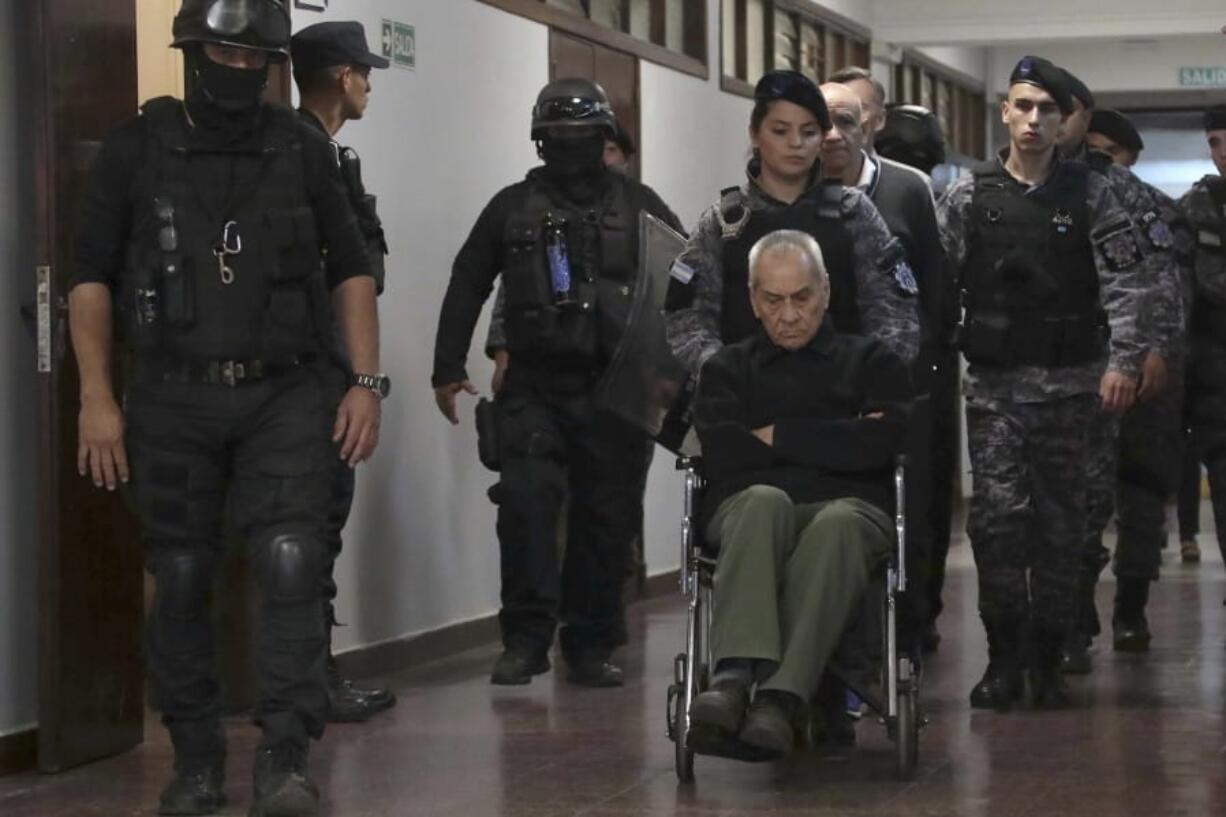 Rev. Nicola Corradi, in wheelchair, Armando Gomez and Rev. Horacio Corbacho, are escorted out of a courtroom, after being found guilty of sexual abuse of deaf children at a Catholic-run school, in Mendoza, Argentina, Monday, Nov. 26, 2019. The court sentenced Rev. Nicola Corradi, to 42 years in prison, and Rev. Horacio Corbacho, to 45 years, for acts that occurred at the Institute in Lujan de Cuyo, a municipality in the northwestern province of Mendoza. The court also sentenced gardener Armando G?mez to 18 years in prison.