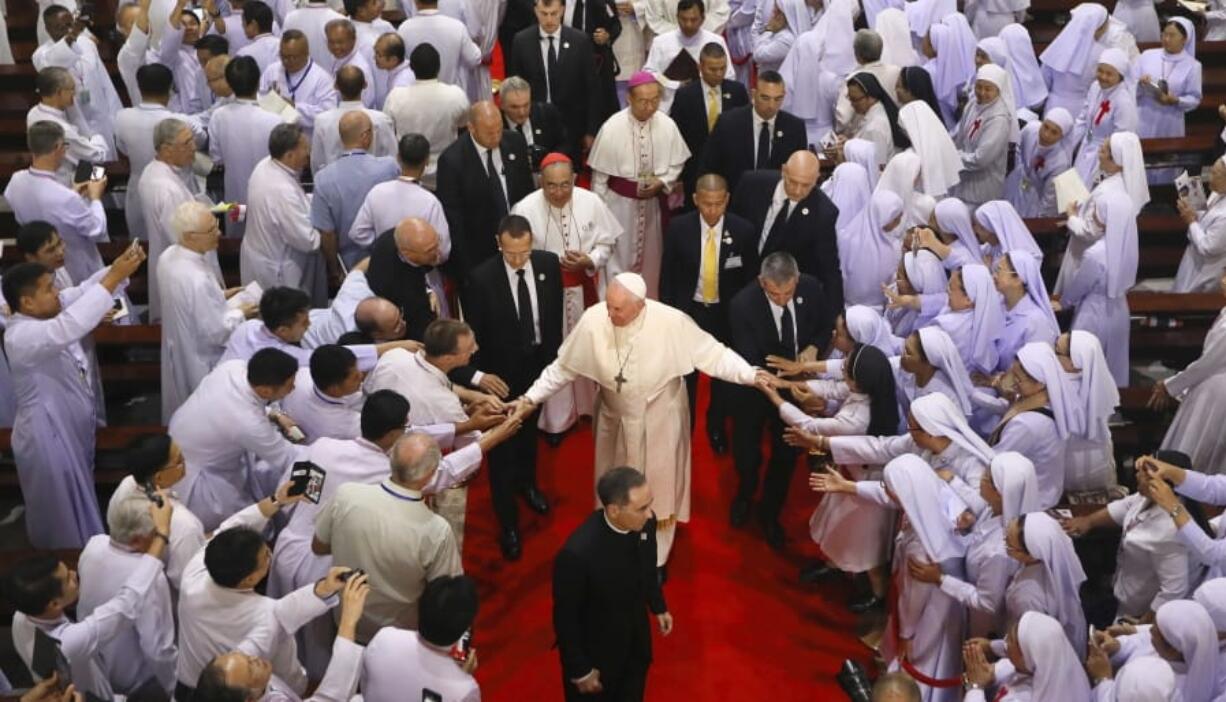 Priests, religious seminarians and Catechists touch the hands of Pope Francis as he leaves after meeting them at Saint Peter&#039;s Parish on the outskirts of Bangkok, Thailand, Friday, Nov. 22, 2019. Pope Francis urged more efforts to combat the &quot;humiliation&quot; of women and children forced into prostitution as he began a busy visit Thursday to Thailand, where human trafficking and poverty help fuel the sex tourism industry.