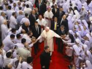 Priests, religious seminarians and Catechists touch the hands of Pope Francis as he leaves after meeting them at Saint Peter&#039;s Parish on the outskirts of Bangkok, Thailand, Friday, Nov. 22, 2019. Pope Francis urged more efforts to combat the &quot;humiliation&quot; of women and children forced into prostitution as he began a busy visit Thursday to Thailand, where human trafficking and poverty help fuel the sex tourism industry.