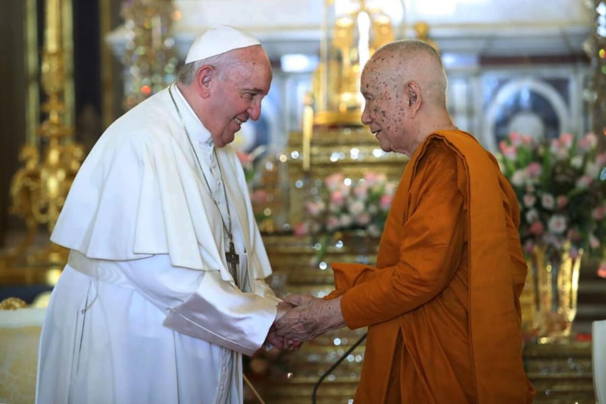 In this photo released by Wat Ratchabophit Sathit Maha Simaram Temple, Pope Francis, left, visits the Supreme Buddhist Patriarch of Thailand Somdet Phra Sangkharat Sakonlamahasangkhaparrinayok at the temple in Bangkok, Thailand Thursday, Nov. 21, 2019.